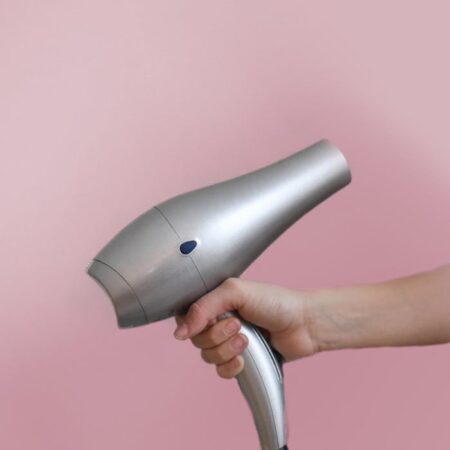 Person Holding Grey Hair Dryer